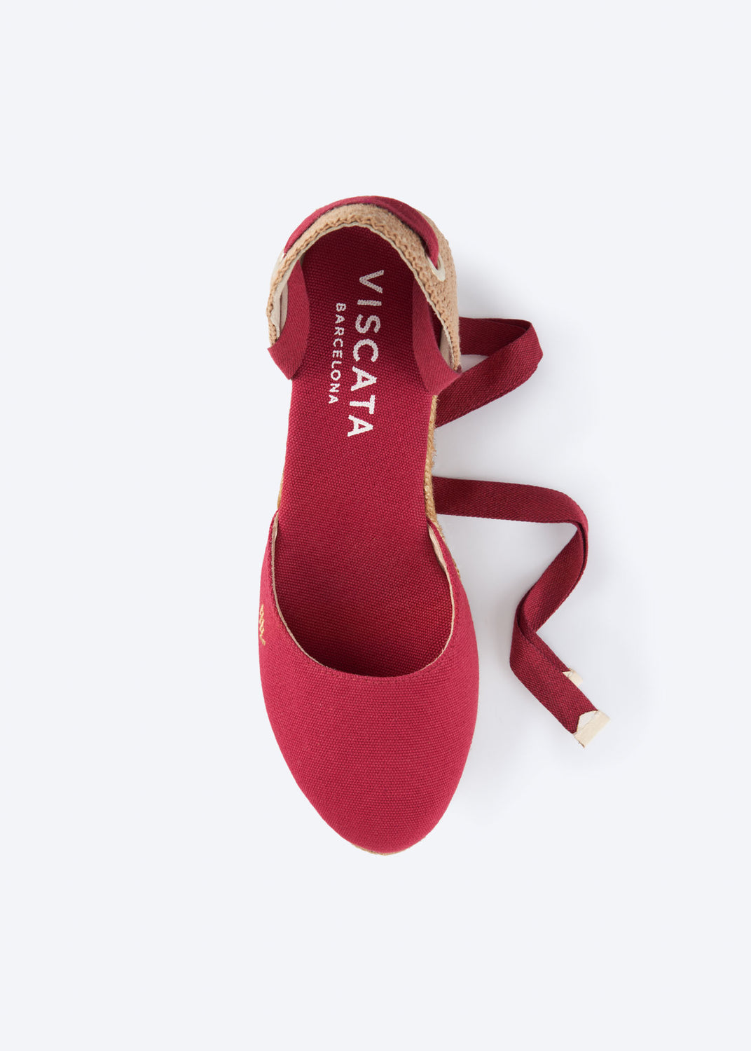 Top view of a cherry red espadrille sandal with wraparound ankle ties and a closed toe, handcrafted in Spain