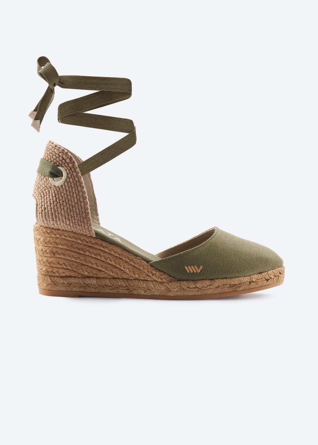 Side view of olive green espadrille wedge sandals with wraparound ankle ties, a closed toe, and natural braided jute heel, handcrafted in Spain