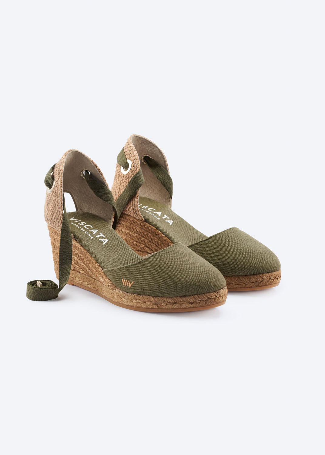 Olive green wedge espadrille sandals with wraparound ankle ties, a closed toe, and natural braided jute wedge, handcrafted in Spain