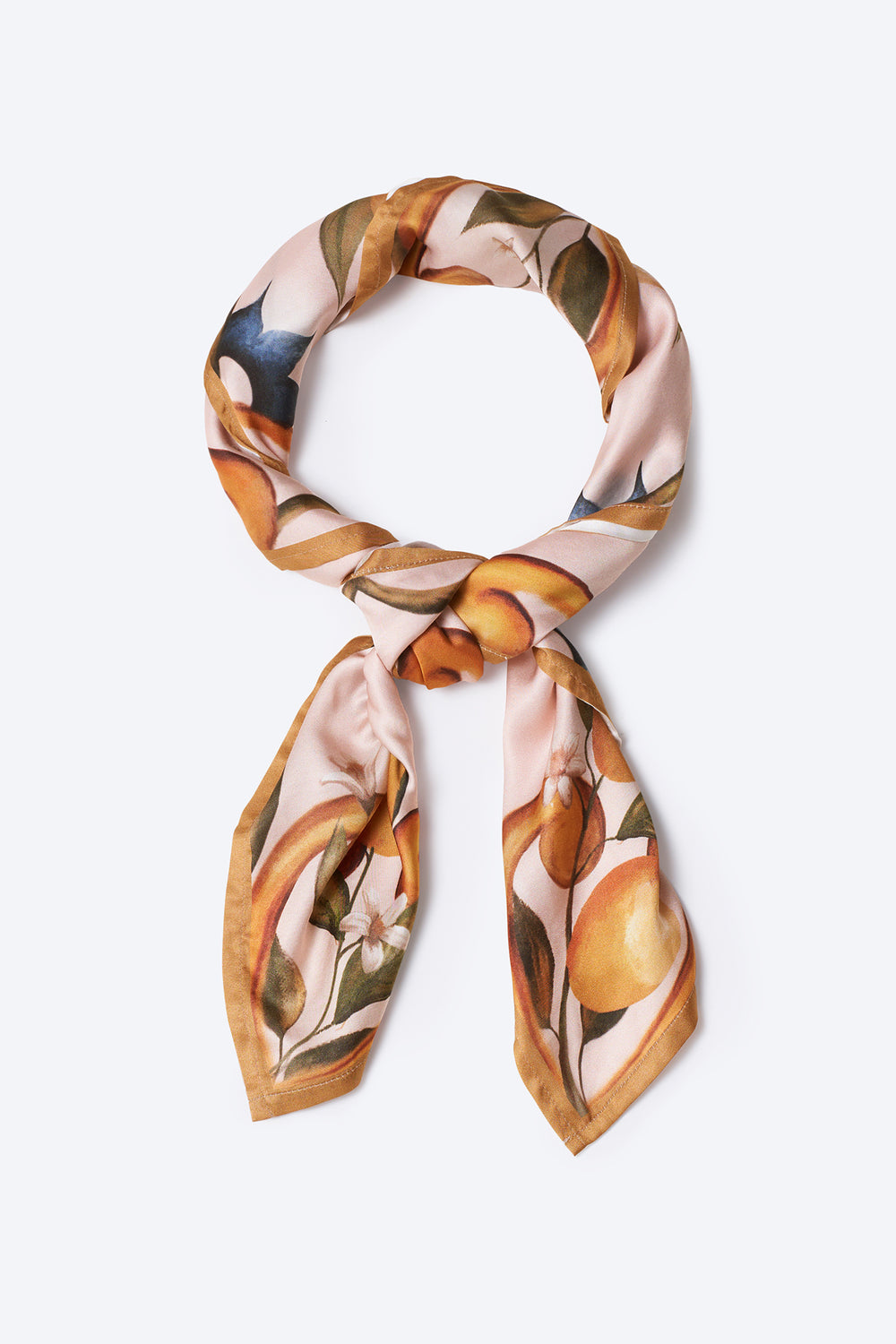 Chic silk neck scarf with hand-painted orange fruit and floral motif on a blush background – stylish and versatile women's accessory perfect for Mediterranean-inspired outfits and elegant summer looks
