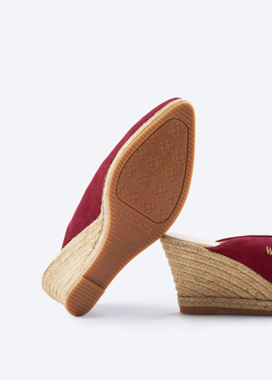 Outsole view of burgundy suede wedge espadrille mules with a pointed closed toe and textured rubber sole, handcrafted in Spain