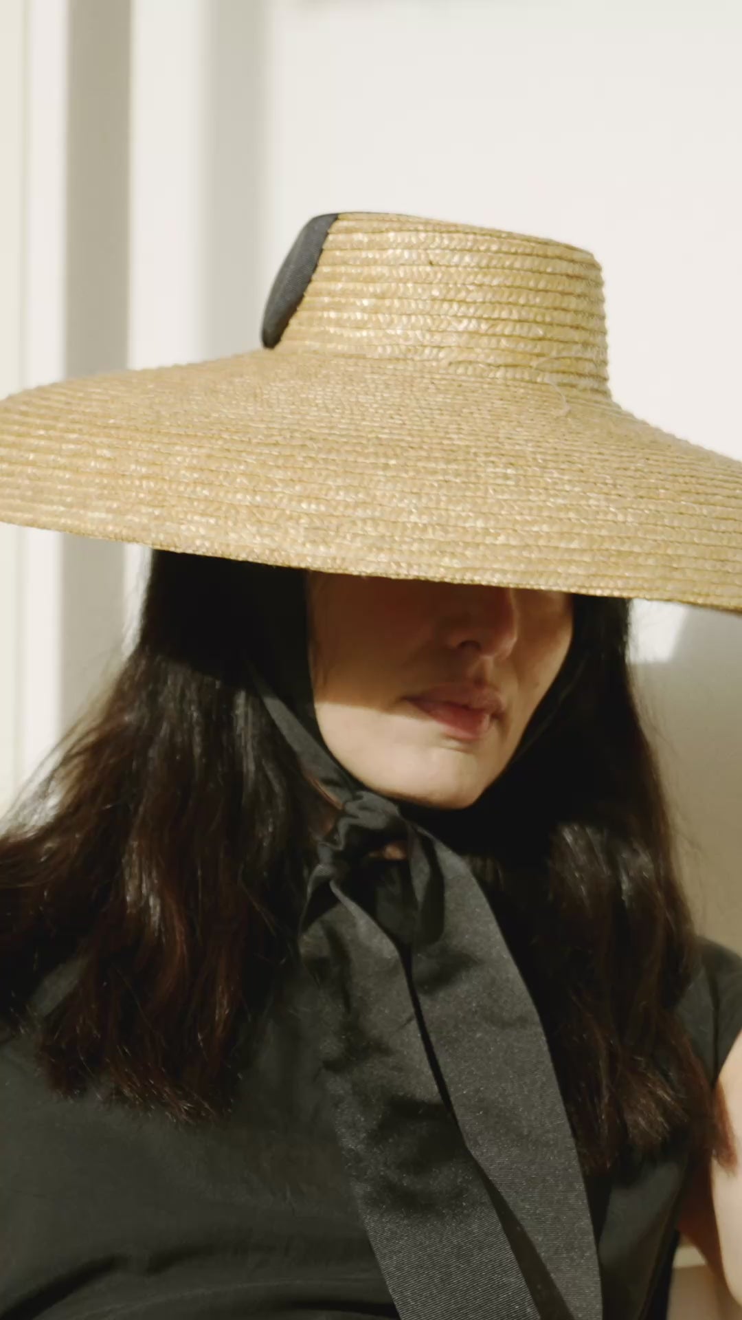 Formiga black canvas ankle strap wedge women espadrilles, shown in motion in a Mediterranean outdoor setting.