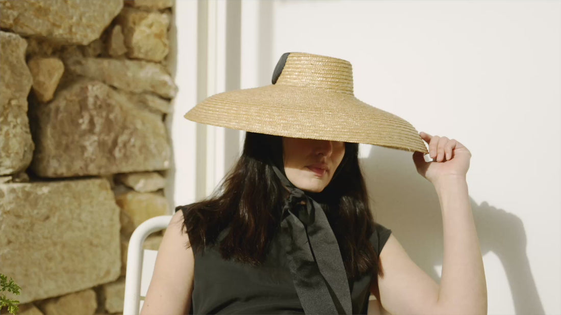 Formiga black canvas ankle strap wedge women espadrilles, styled in a Mediterranean outdoor setting.