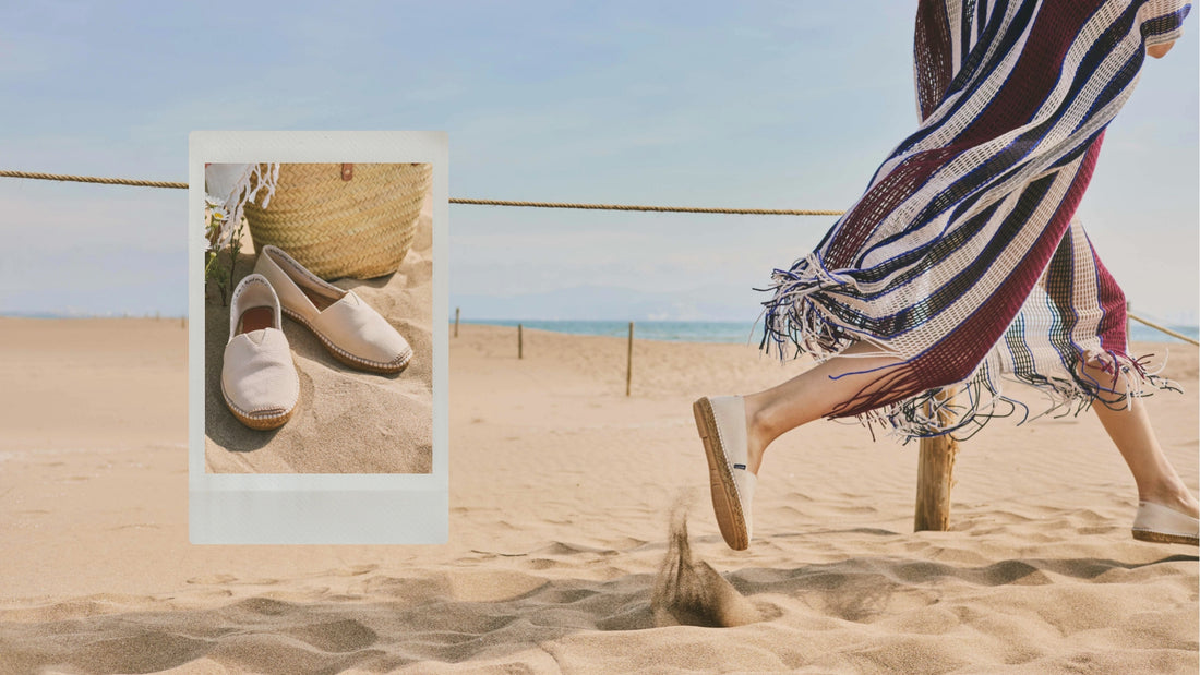 Person walking on a sandy beach with a striped towel and sandals, framed by a polaroid-style border.