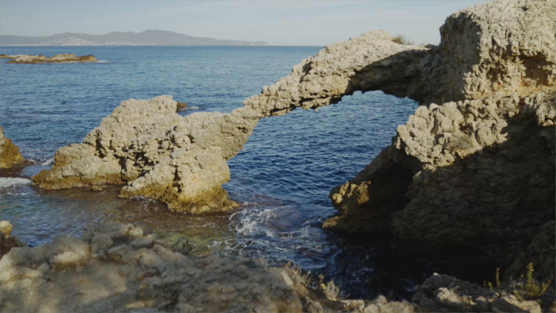 Coastal hero video featuring black canvas slip-on espadrille wedges with a jute-wrapped wedge sole